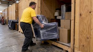 Mover loading household belongings into a storage vault